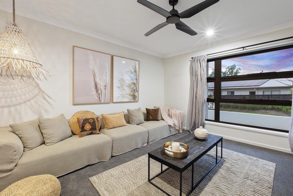 A living room filled with furniture and a large window