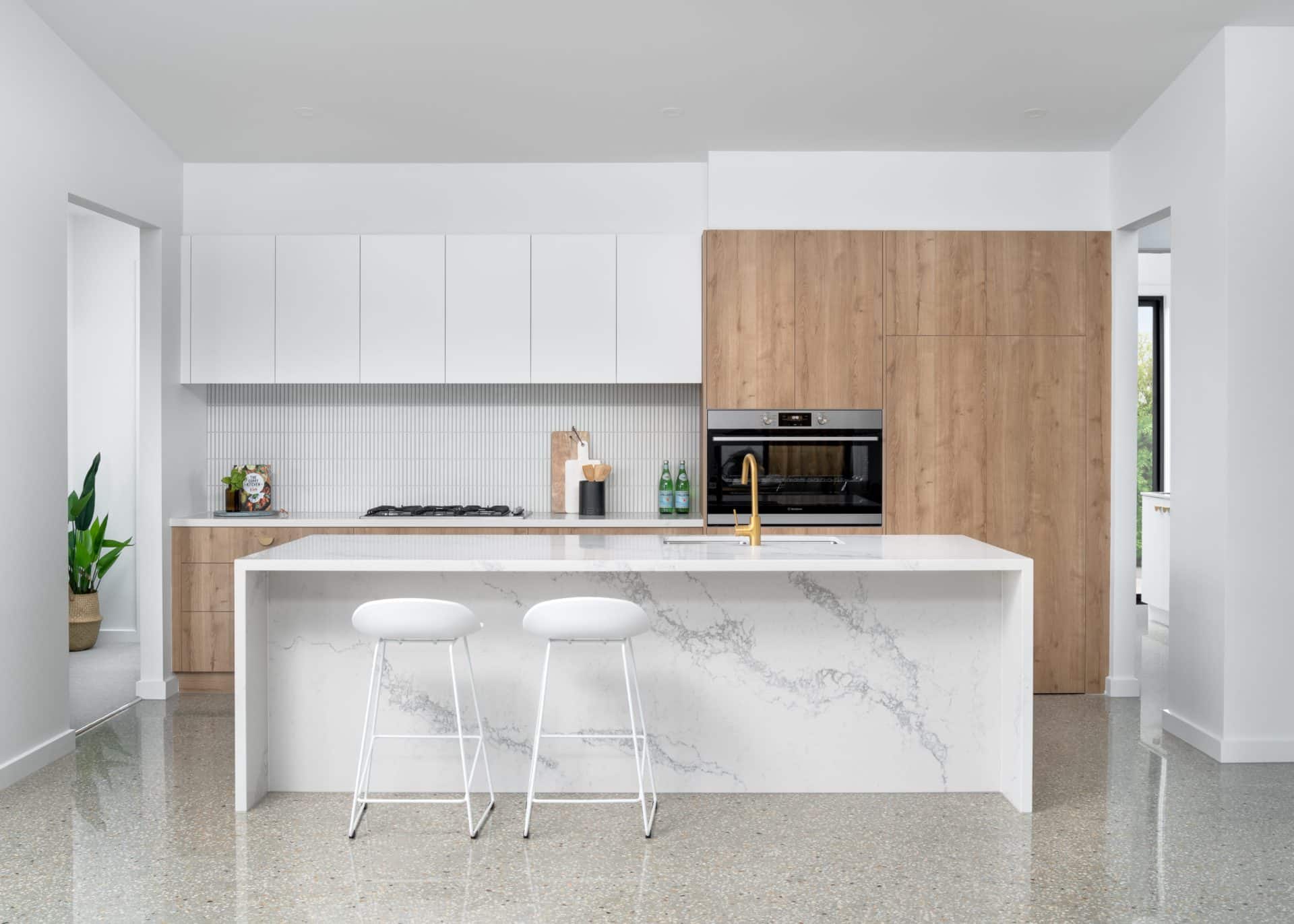 Kitchen finishes with stone benchtop, timber cabinetry and pendant lighting