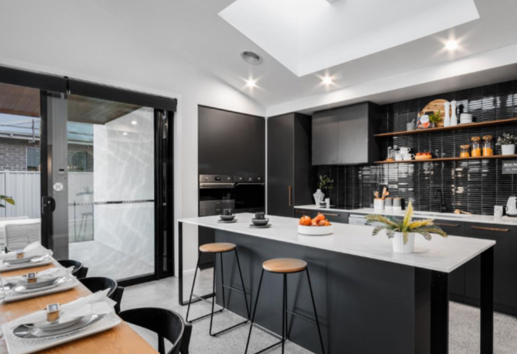 Skylights give a modern look to this black and moody kitchen. 