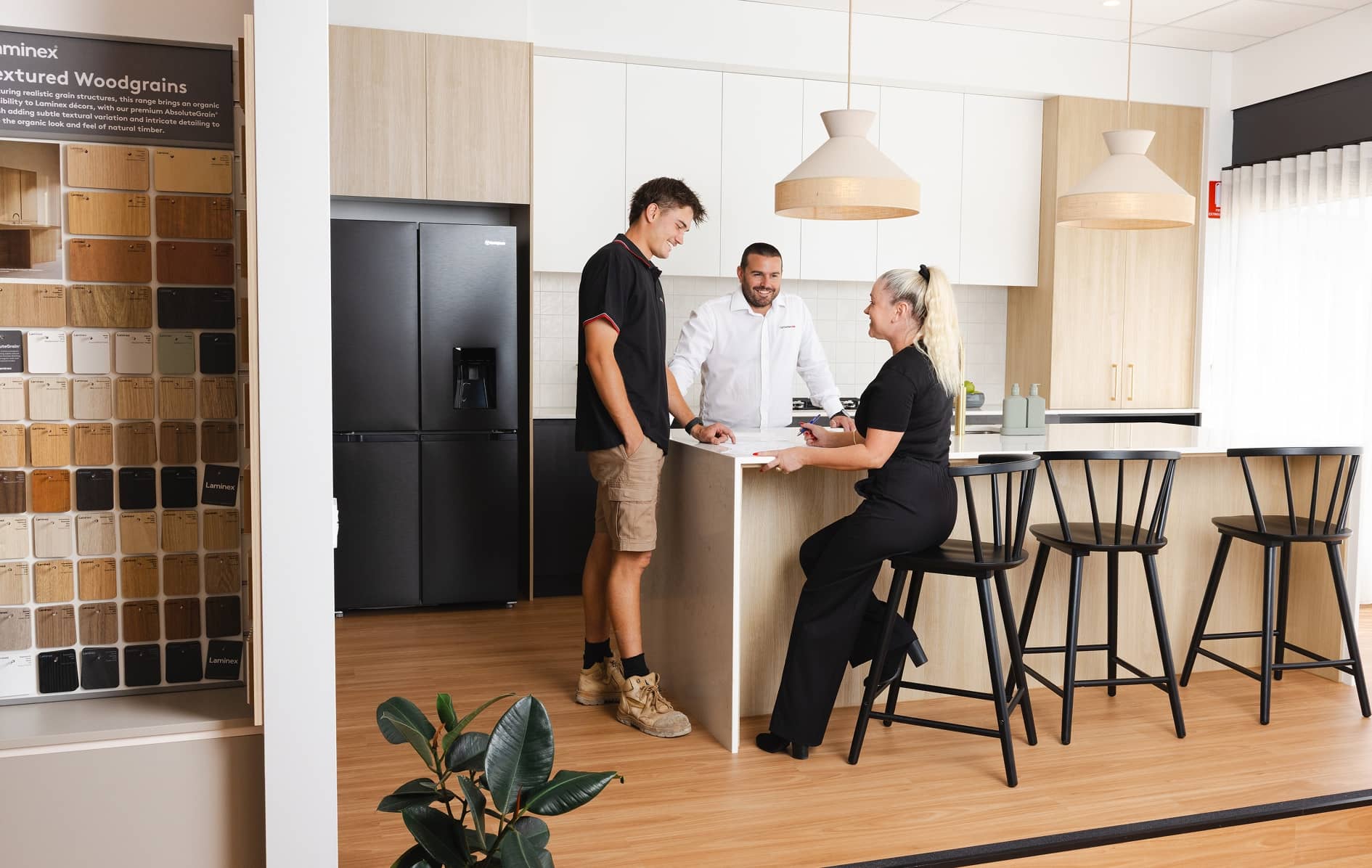 Family planning their new home in an open-plan kitchen and living space